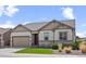 Charming home featuring stone accents, a well-manicured lawn, and a cozy seating area on the front porch at 6420 Agave Ave, Castle Rock, CO 80108