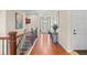 Bright and airy foyer with hardwood floors leading to a staircase with dark metal railing, and a view of the front door at 6420 Agave Ave, Castle Rock, CO 80108
