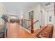 Bright foyer with hardwood floors, staircase with ornate railing, and views into a well-lit living room at 6420 Agave Ave, Castle Rock, CO 80108