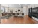 Modern kitchen with white cabinets, a granite island, and hardwood floors at 6420 Agave Ave, Castle Rock, CO 80108