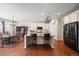 Modern kitchen island with seating and stainless steel appliances, overlooking a cozy breakfast nook at 6420 Agave Ave, Castle Rock, CO 80108