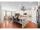 Open-concept kitchen with island and seating overlooking the breakfast nook with natural light at 6420 Agave Ave, Castle Rock, CO 80108