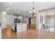 Open kitchen with an island, granite countertops, and stainless steel appliances flows into a dining and living area at 6420 Agave Ave, Castle Rock, CO 80108