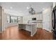 Bright kitchen boasts an island, stainless steel appliances, granite countertops, and decorative wrought iron light fixtures at 6420 Agave Ave, Castle Rock, CO 80108