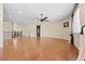 Open-concept living room featuring hardwood floors, a ceiling fan, and seamless transition to other living spaces at 6420 Agave Ave, Castle Rock, CO 80108