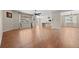 Spacious living room featuring hardwood floors, a ceiling fan, and plenty of natural light from the large window at 6420 Agave Ave, Castle Rock, CO 80108