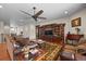 Bright living room featuring hardwood floors, a ceiling fan, and a built-in entertainment center at 6420 Agave Ave, Castle Rock, CO 80108