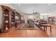 Expansive living room showcasing hardwood floors, a built-in entertainment center, and plush seating with a ceiling fan at 6420 Agave Ave, Castle Rock, CO 80108