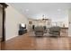 Open-concept living room with a large window, wood floors, and recessed lighting at 6420 Agave Ave, Castle Rock, CO 80108