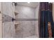 Tiled shower stall with a modern showerhead and decorative tile accents at 6420 Agave Ave, Castle Rock, CO 80108