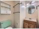 Retro bathroom with a pastel green toilet and a wood vanity with peach-colored sink at 1060 S Coffman St, Longmont, CO 80501