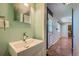 Bathroom featuring a modern vanity and a glimpse of additional living spaces at 1060 S Coffman St, Longmont, CO 80501