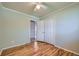 Bedroom with hardwood floors, closet, ceiling fan, and a view to the hallway at 1060 S Coffman St, Longmont, CO 80501