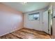 Bedroom featuring hardwood floors, a large window, neutral walls, and ample natural light at 1060 S Coffman St, Longmont, CO 80501
