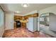 Functional kitchen featuring tiled flooring, ample wood cabinets, and black appliances at 1060 S Coffman St, Longmont, CO 80501