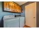 Laundry room with a washer and dryer and wooden cabinets at 1060 S Coffman St, Longmont, CO 80501