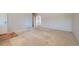 Spacious living room with neutral-toned carpet and arched doorway to other living spaces at 1060 S Coffman St, Longmont, CO 80501