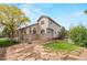 Lush backyard featuring a stone patio and mature trees at 9432 La Quinta Way, Lone Tree, CO 80124