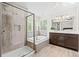 A full bathroom features a soaking tub, walk-in shower with glass door, and a vanity with double sinks at 9432 La Quinta Way, Lone Tree, CO 80124