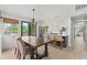 Dining room with hardwood floors open to a modern kitchen with stainless steel appliances and a gas range at 9432 La Quinta Way, Lone Tree, CO 80124