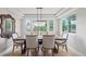 Elegant dining room with chandelier and large windows, perfect for gatherings at 9432 La Quinta Way, Lone Tree, CO 80124