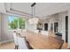 Bright dining room with hardwood floors and modern lighting, seamlessly connecting to the living spaces at 9432 La Quinta Way, Lone Tree, CO 80124
