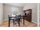 Dining room with dark wood table and chairs, complemented by a classic hutch at 9432 La Quinta Way, Lone Tree, CO 80124