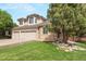 Lovely two-story home featuring a brick and siding facade and a three-car garage with beautifully maintained landscaping at 9432 La Quinta Way, Lone Tree, CO 80124
