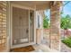 Close-up of front door with sidelight, showcasing a welcoming entrance and stylish details at 9432 La Quinta Way, Lone Tree, CO 80124