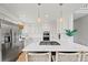 Bright open concept kitchen features a gas range, white countertops, and stainless steel appliances at 9432 La Quinta Way, Lone Tree, CO 80124