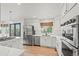 Bright kitchen featuring stainless steel appliances, a gas range, white cabinets and hardwood floors at 9432 La Quinta Way, Lone Tree, CO 80124