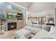 Open concept living space with a fireplace, open dining area and a modern kitchen with stainless steel appliances at 9432 La Quinta Way, Lone Tree, CO 80124