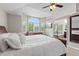 This main bedroom offers neutral walls, large windows, and entrance to the ensuite bath with soaking tub at 9432 La Quinta Way, Lone Tree, CO 80124