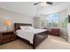 A main bedroom boasts a vaulted ceiling, ceiling fan, large window and plush neutral carpet at 9432 La Quinta Way, Lone Tree, CO 80124