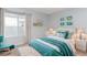 Cozy bedroom with a large window, neutral walls, and a comfortable bed with stylish bedding at 10722 E Exposition Ave # 314, Aurora, CO 80012