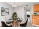 Cozy dining area with a glass table and modern chandelier at 10722 E Exposition Ave # 314, Aurora, CO 80012