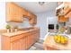 Well-lit kitchen features light wood cabinets and modern appliances at 10722 E Exposition Ave # 314, Aurora, CO 80012