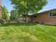 Backyard featuring a covered patio and a lush green lawn at 945 Emerald St, Broomfield, CO 80020
