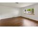 Empty bedroom featuring hardwood floors and a window with natural light at 945 Emerald St, Broomfield, CO 80020