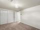 A carpeted bedroom offers a spacious closet and neutral palette, ready for personalized touches at 945 Emerald St, Broomfield, CO 80020