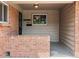 Charming front porch featuring a brick facade and classic house number display, inviting warmth and character at 945 Emerald St, Broomfield, CO 80020
