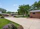 Well-maintained front yard with a large driveway and landscaped garden beds at 945 Emerald St, Broomfield, CO 80020