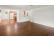 Open concept living room with hardwood floors leading into the adjacent kitchen at 945 Emerald St, Broomfield, CO 80020