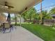 Covered patio featuring an outdoor dining set and a view of the green backyard at 945 Emerald St, Broomfield, CO 80020