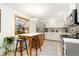 Updated kitchen featuring white cabinets and a quartz countertop at 11368 Lamar St, Westminster, CO 80020