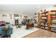 Bright living room with comfy seating and built-in shelving at 11368 Lamar St, Westminster, CO 80020