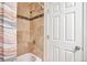 Close-up of the tiled shower/tub with a shower head and hardware at 13462 E Asbury Dr, Aurora, CO 80014