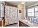 Bathroom with a single sink vanity with granite countertop, tub and a shower at 13462 E Asbury Dr, Aurora, CO 80014
