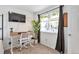Functional bedroom workspace featuring a modern desk, chair, and ample natural light from the window at 13462 E Asbury Dr, Aurora, CO 80014