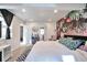 Spacious bedroom with stylish botanical wallpaper, a cozy rug, and access to ensuite bathroom at 13462 E Asbury Dr, Aurora, CO 80014